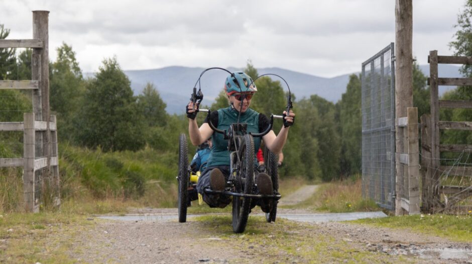 Caroline powers through the hills on her e-assisted hand cycle. Image: Stefan Morrocco.