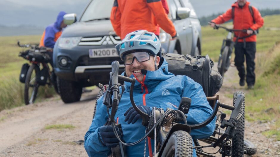 Neil is full of smiles as he prepares to cycle into the Perthshire wilderness. Image: Stefan Morrocco.