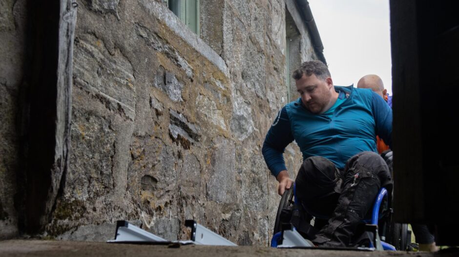 Neil makes his way into the bothy via an access ramp. Image: Stefan Morrocco.