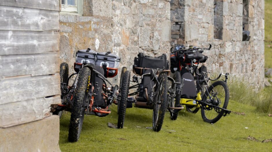 The state-of-the-art e-assist hand cycles lined up against the secret bothy. Image: Stefan Morrocco.