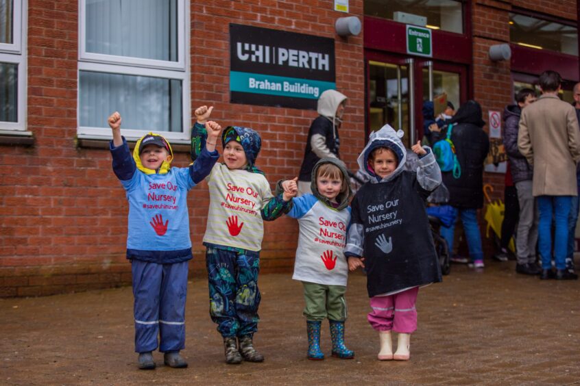 Four children in 'save our nusery' T shirts outside UHI Perth building