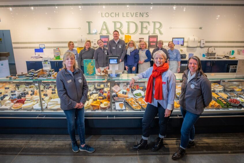 Emma Niven with smiling staff members at Loch Leven's Larder food hall