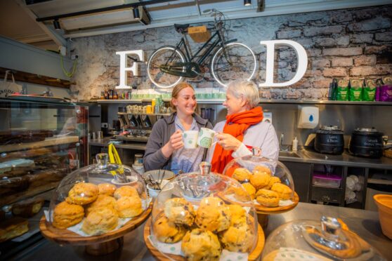 Portia Corcoran and Emma Niven standing behind table of food at loch leven's Larder, Kinross