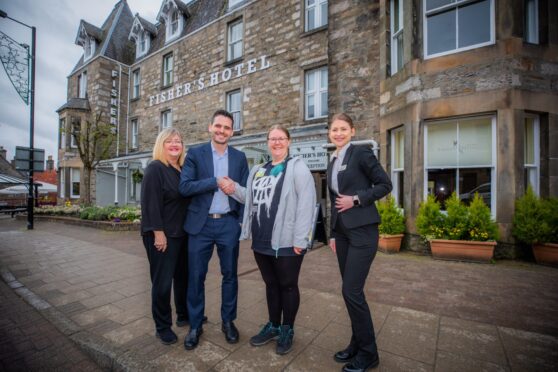 Four people standing outside Fisher's Hotel, Pitlochry