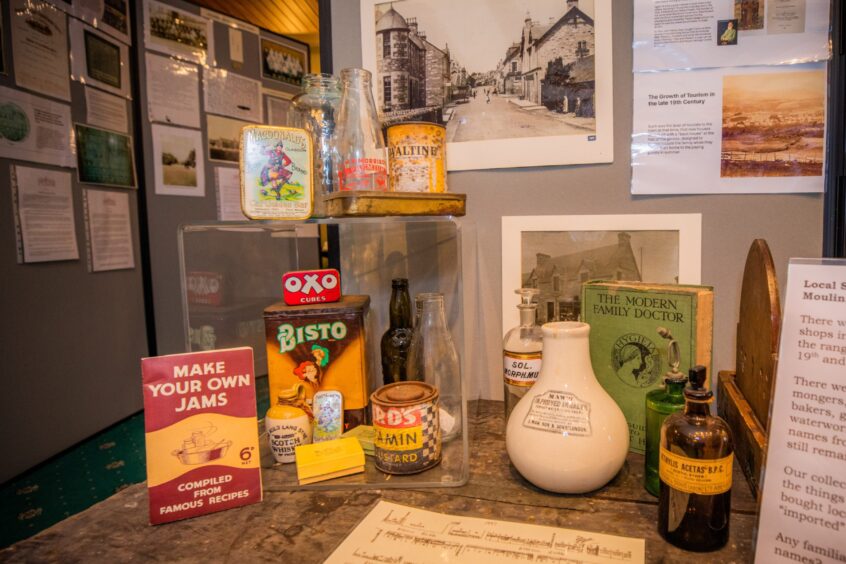 Collection of items, including old Bisto and Oxo tins, stoneware bottles, and a book titled make Your Own jams
