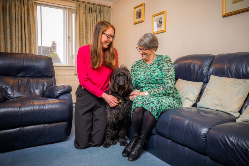 Laura Davidson (left) and mother Gillian Davidson (right) alongside fostered guide dog Rascan.