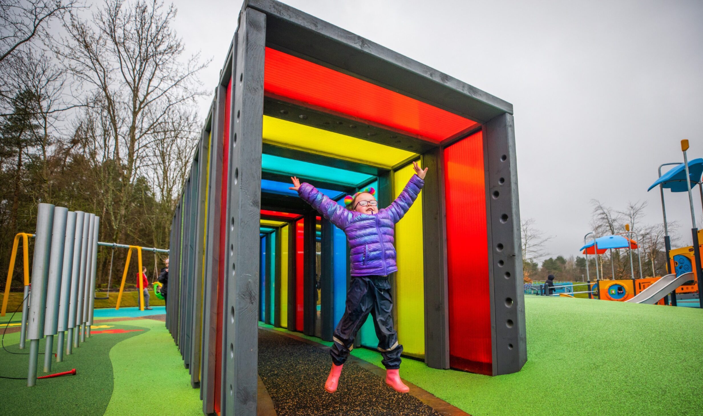 Ava Paterson jumping in a colourful tunnel at Lochore Meadows play park.