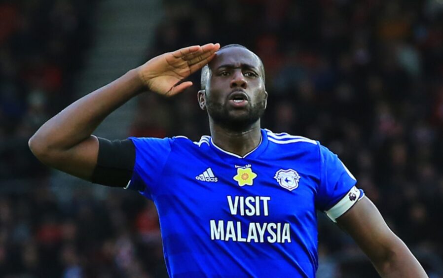 Sol Bamba makes a salute playing for Cardiff City.