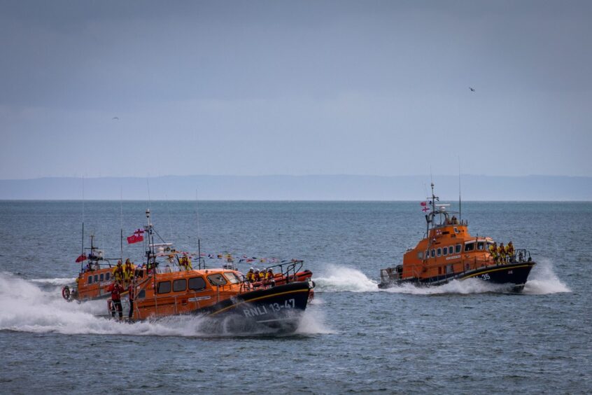 RNLI boat escort the new Anstruther lifeboat home for the first time.