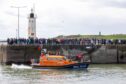Crowds line the harbour to welcome RNLB Robert and Catherine Steen to Anstruther. Image: Steve Brown/ DC Thomson
