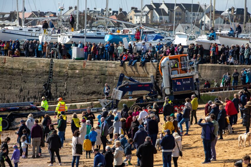 Large crowd watches homecoming of new Anstruther lifeboat.