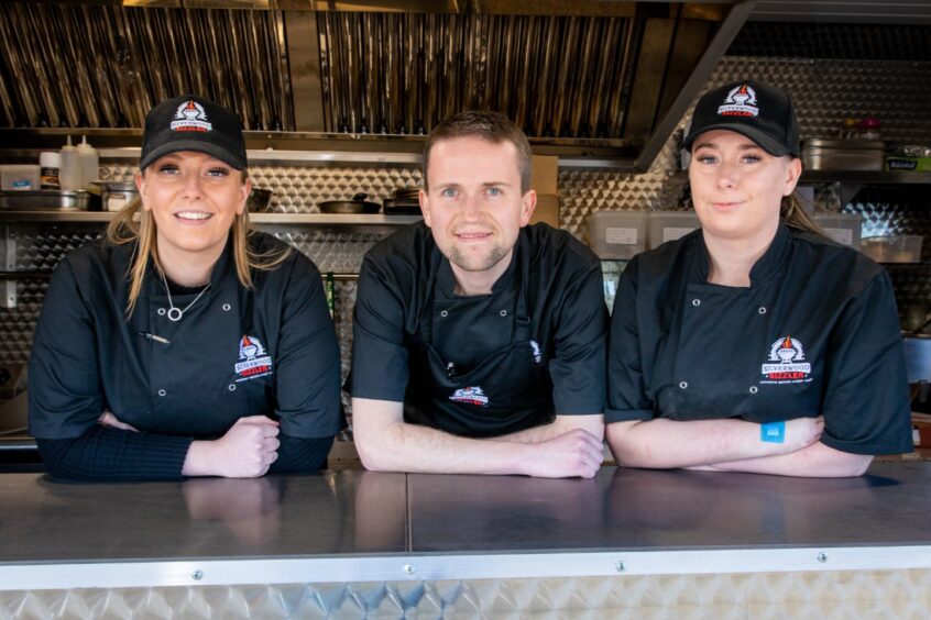 The team at the Silverwood Sizzler Perthshire food truck smile at the camera. 