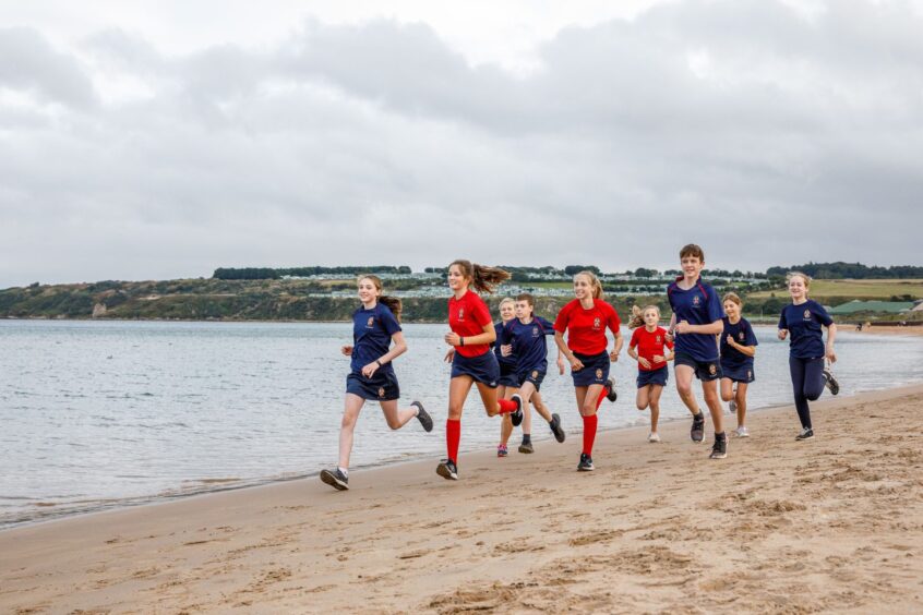 St Leonards School pupils running on St Andrews Beach