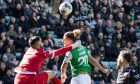 St Johnstone goalkeeper Dimitar Mitov,who came close to conceding a penalty against Hibs on Saturday, challenges a Hibs player for a high ball.