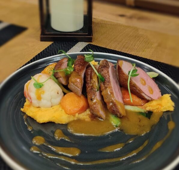 A main dish from The Fern Cottage Restaurant in Pitlochry, the duck breast served with red pesto mash potato, roast veg and chilli and apricot sauce.