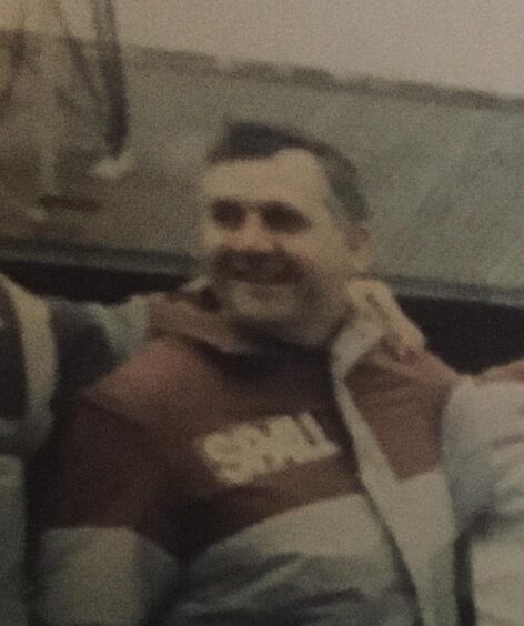 Jimmy Carle smiling in tracksuit in 1990s photo
