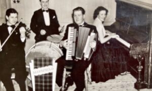 Joan Blue playing piano in black and white photo of Scottish country dance band quartet