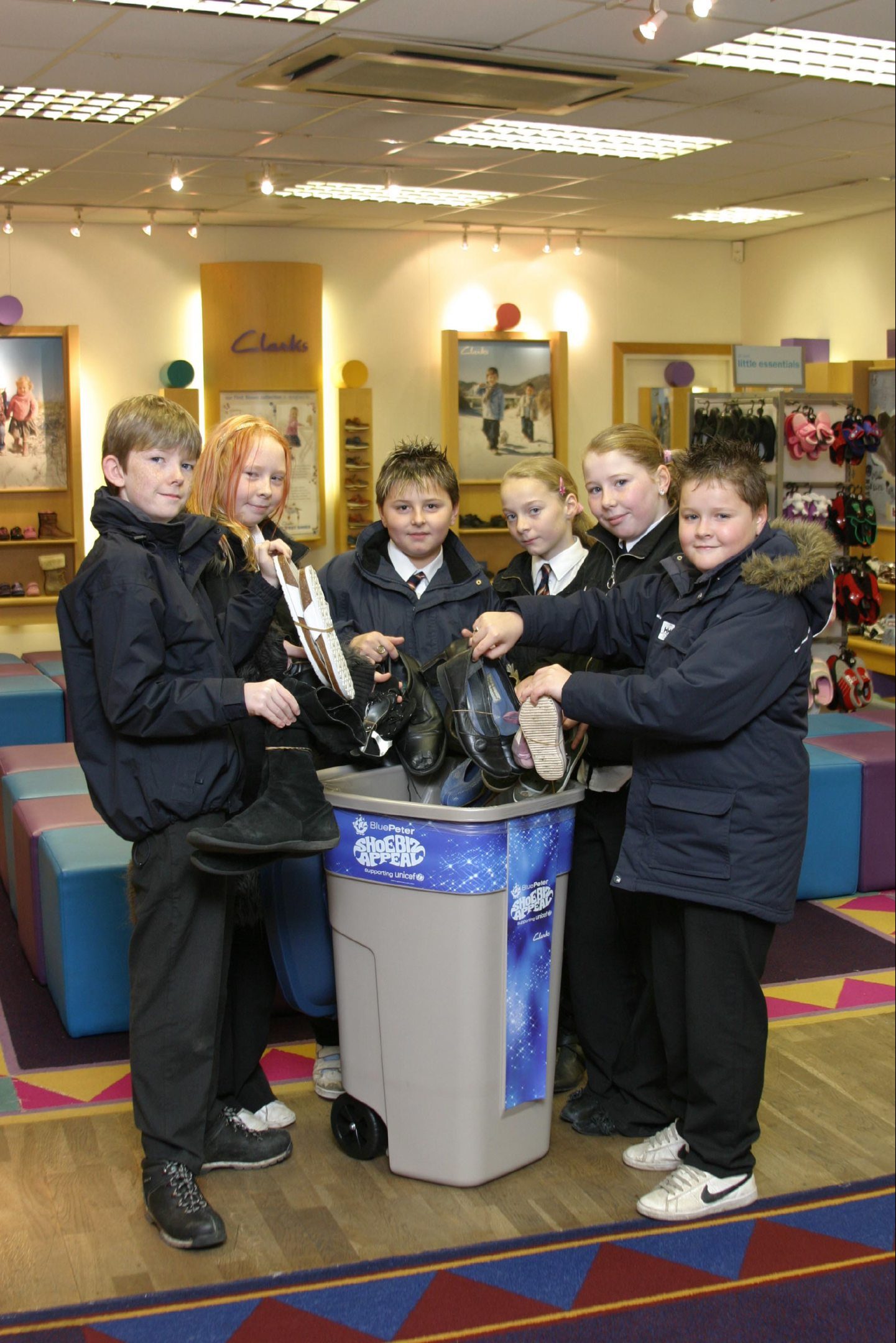 Whitfield Primary pupils handed over 300 pairs of shoes in 2006. Some are pictured putting shoes in a collection bin.