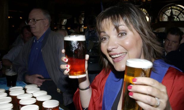 Lorraine Kelly enjoys a pint at the Trades House in 2004.