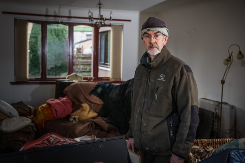 David Scott inside his flooded Brechin home a few weeks after Storm babet hit. Image: Mhairi Edwards.