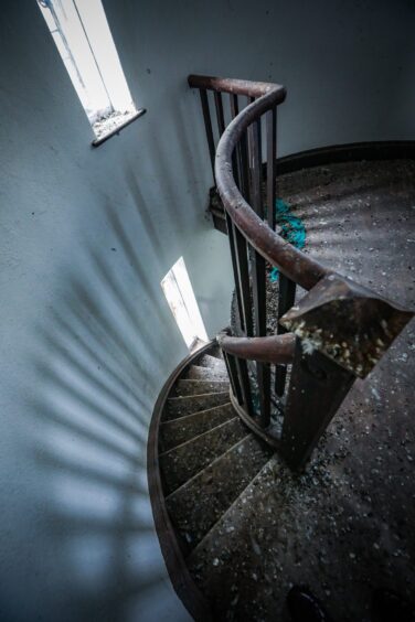 The winding, cobweb-strewn, stairway up to the tower room.