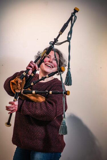 Collections technician Jen Falconer with a set of bagpipes ready for display.