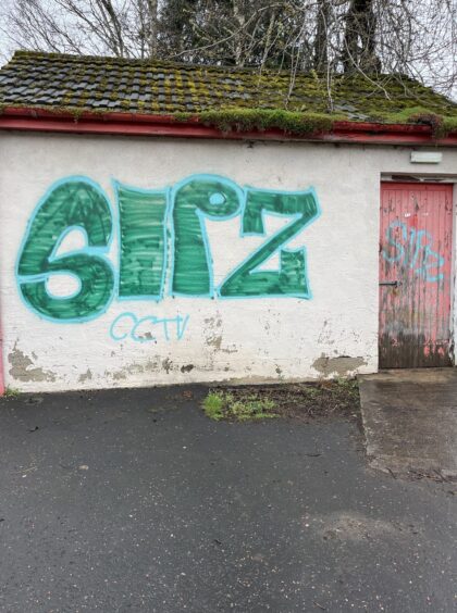 Shed with graffiti in large letters
