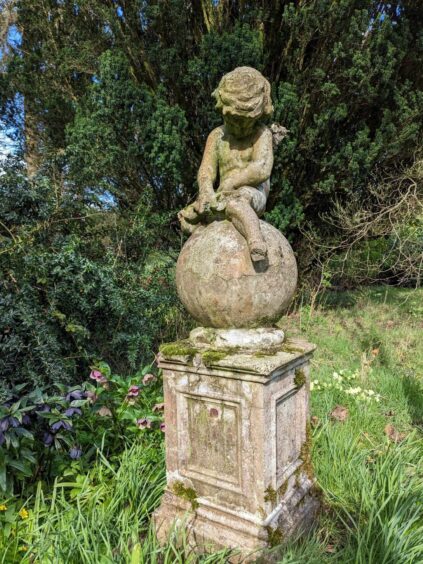 A cute statue of Cupid in the Vinny Garden at Pitmuies.