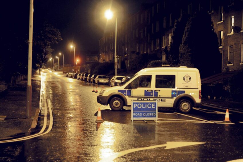 A police road closure during flooding on Dens Road in 2013.