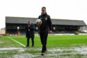 Referee Don Robertson postponed the Dundee match after inspecting Dens Park