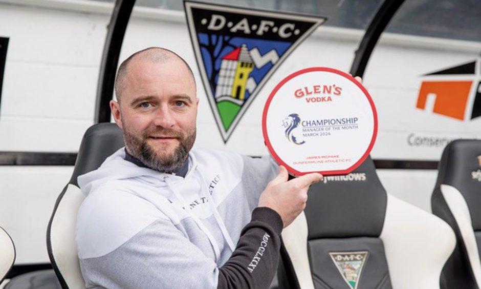 Former Dunfermline Athletic F.C. boss James McPake holds up the manager of the month trophy for March.