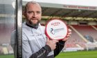 James McPake holds up his manager of the month award at Dunfermline's East End Park stadium.