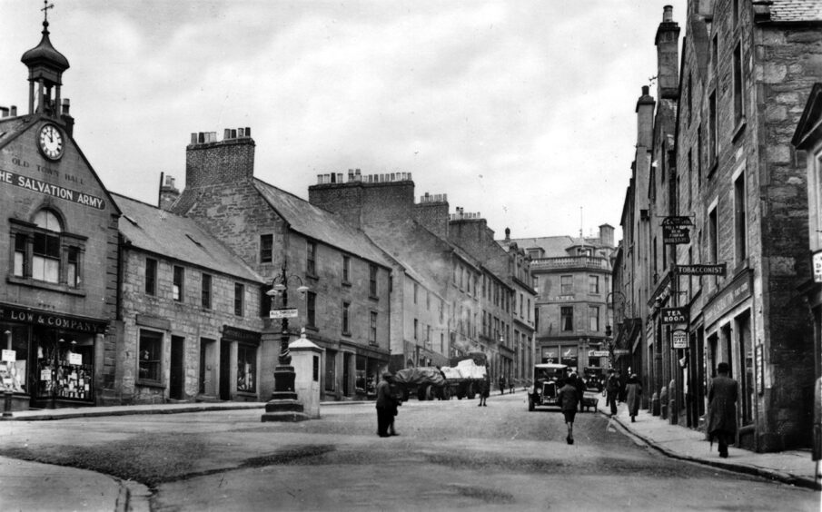 William Low can be seen to the left of the mercat cross in Brechin town centre