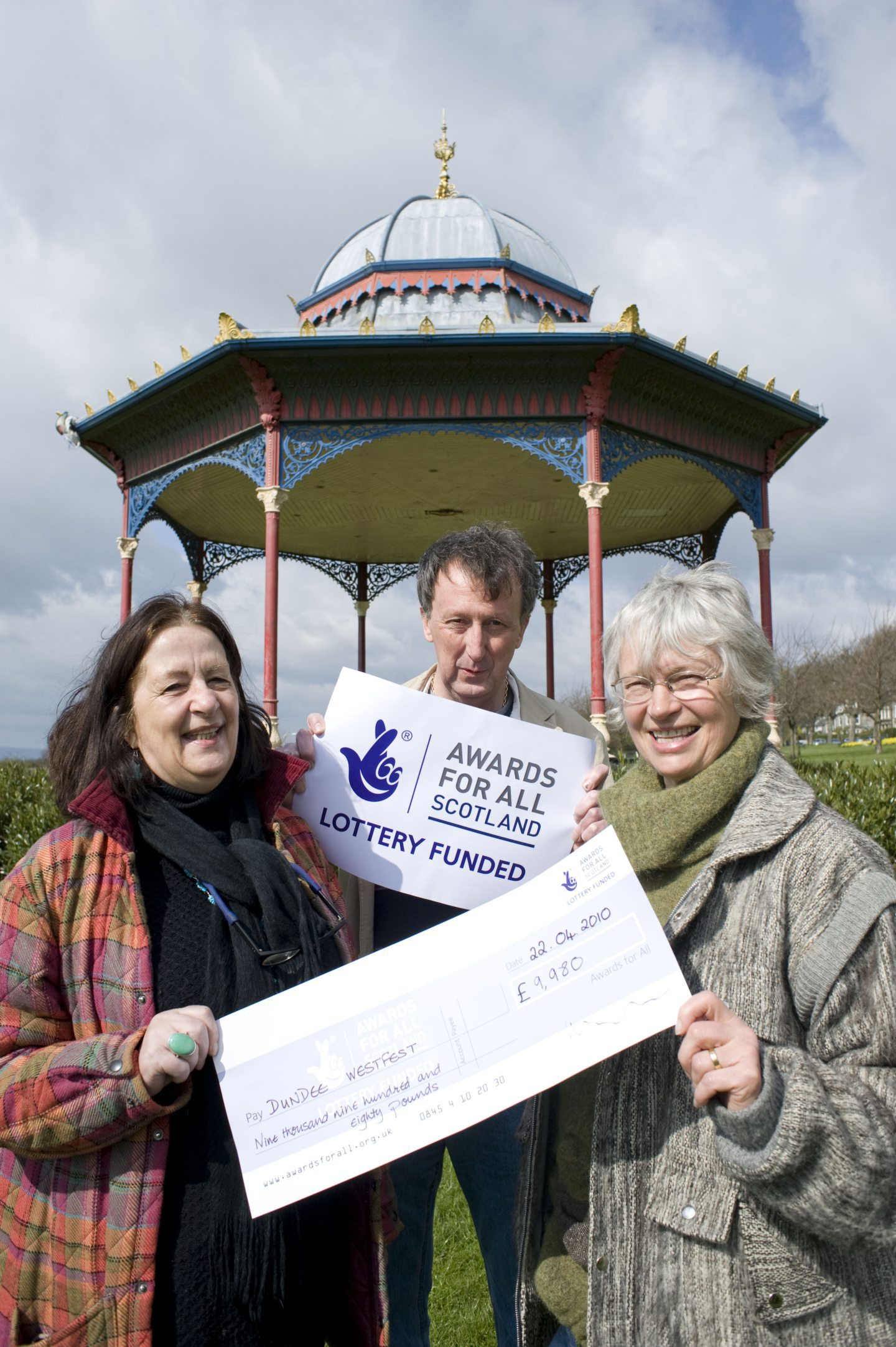 Kay Macfarlane, Sandy Greenhorn and Liz Broumley hold aloft a cheque as they announce the lottery funding for the first Westfest. 