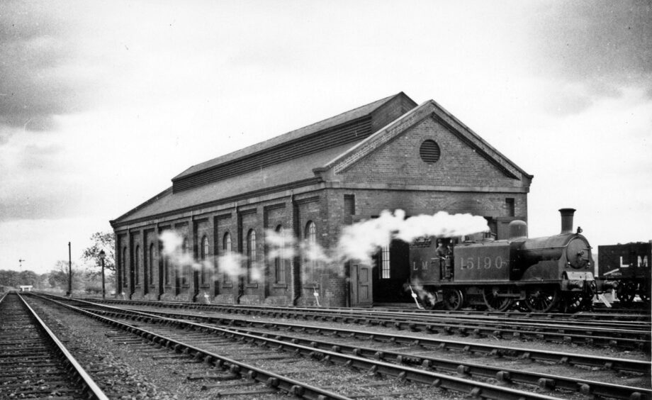 A tank locomotive is seen here standing outside the small local engine shed in 1936.