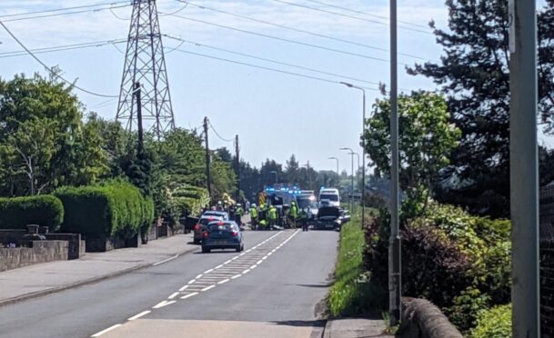 A two-car crash has closed the A923 Coupar Angus Road at Birkhill.