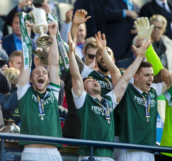 Lewis Stevenson throws his hands in the air and looks to the sky as Hibernian lift the Scottish Cup in 2016.