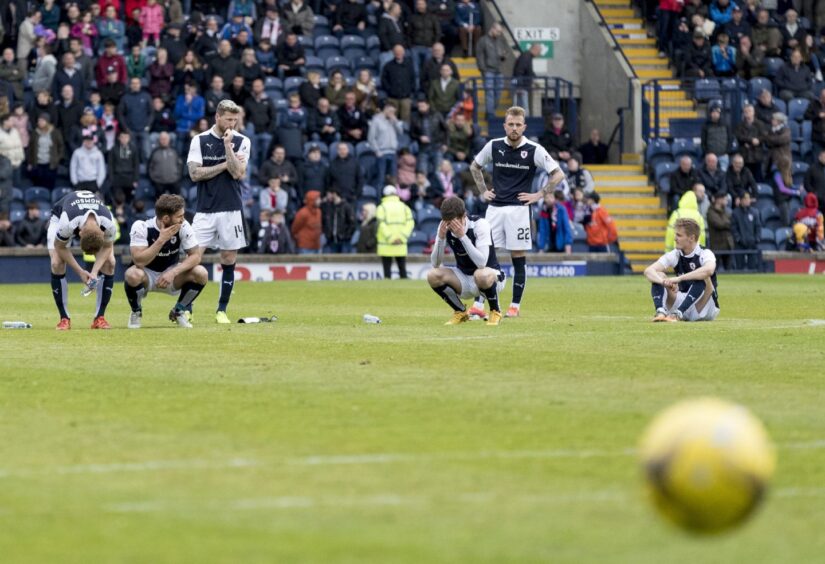 Raith Rovers players stand in disbelief and dejection on the pitch at Stark's Park following relegation in 2017.
