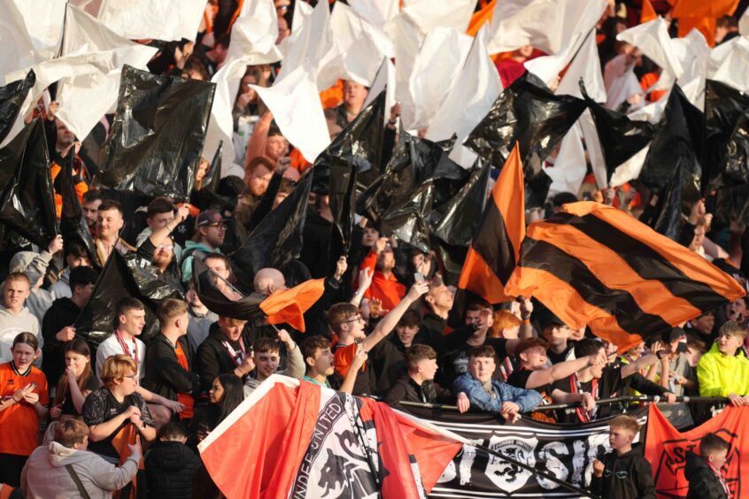 Dundee United fans wave flags.