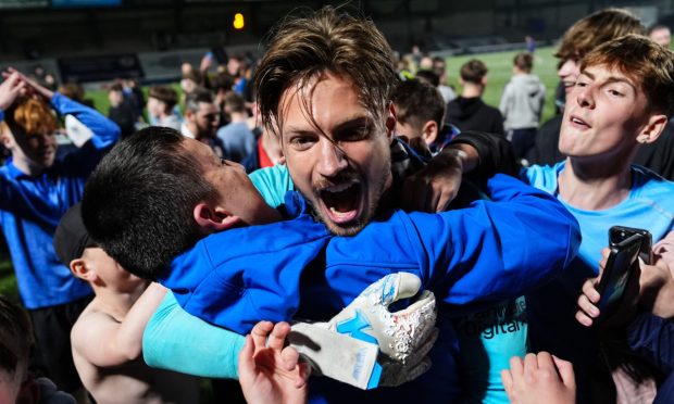 Kevin Dabrowski is mobbed by Raith Rovers supporters following the play-off semi-final victory over Partick Thistle. Image: Stuart Wallace / Shutterstock.