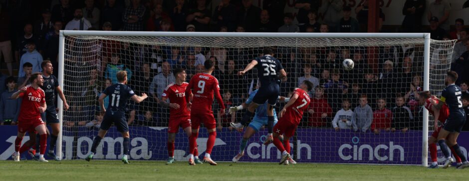 Will Nightingale hits the post for Ross County.