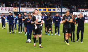 Dundee boss Tony Docherty and his players thank the Dens Park support at full-time. Image: Shutterstock