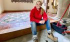 Tracey Beaton sits on her mosaic tile floor of the Culdees Castle chapel, which she got married in.
