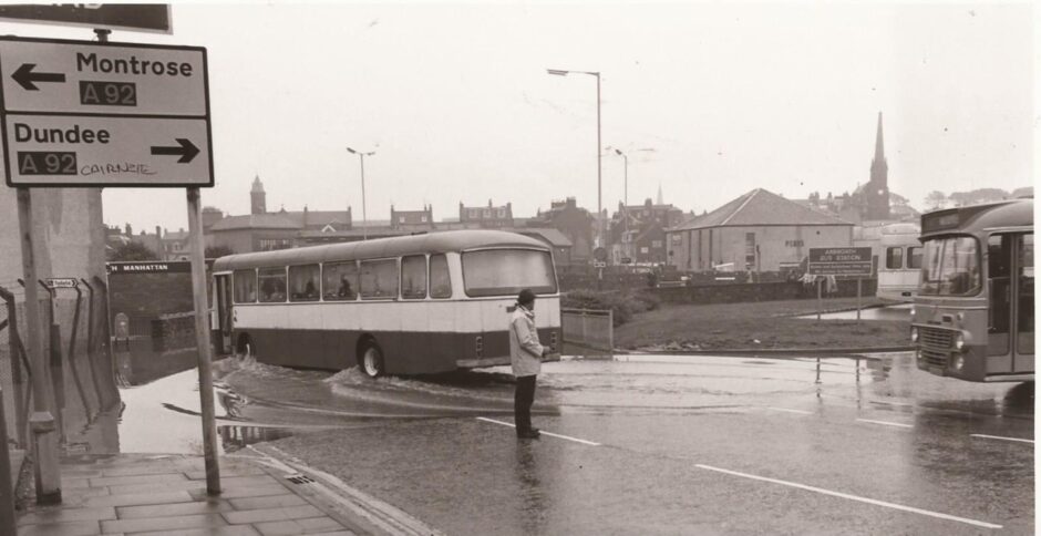 A buses drives through flooding in Catherine Street in 1985.