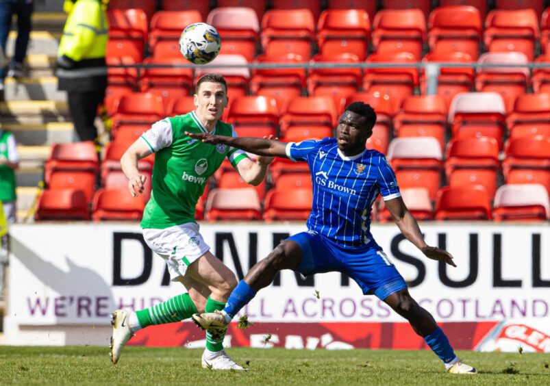 Hibernian defender Paul Hanlon and St Johnstone striker Adama Sidibeh challenge for the ball.