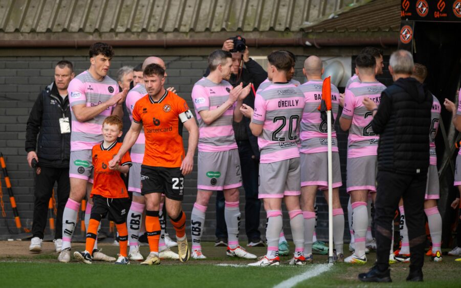 The Partick Thistle squad give Dundee United - led by ex-Jags skipper Ross Docherty - a guard of honour