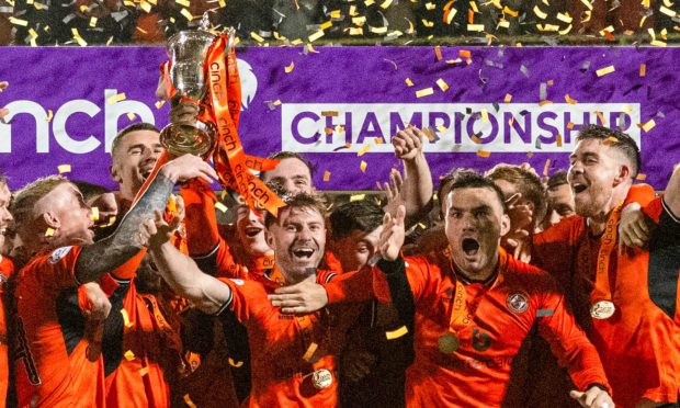 Ross Docherty lifts the Championship trophy after Dundee United hammered his former club