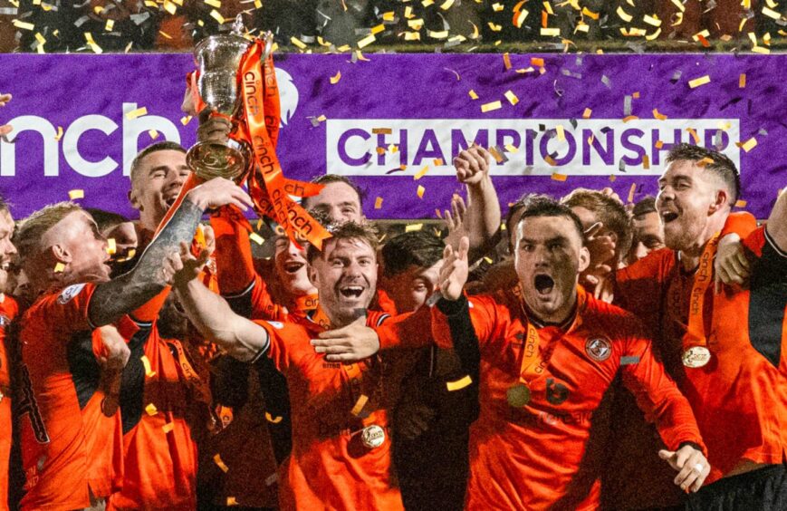 Ross Docherty holds the Championship trophy aloft.
