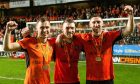 Jordan Tillson, left, David Wotherspoon and Louis Moult celebrate United's title win