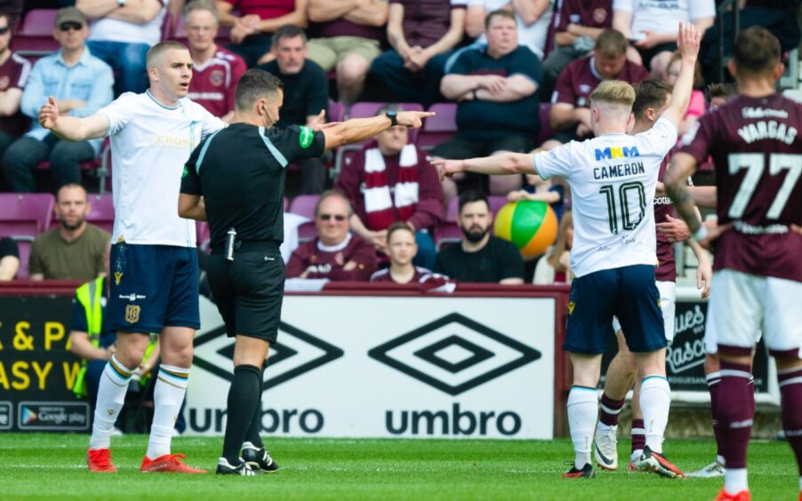 Nick Walsh points to the spot before over-ruling the penalty for Dundee. Image: SNS